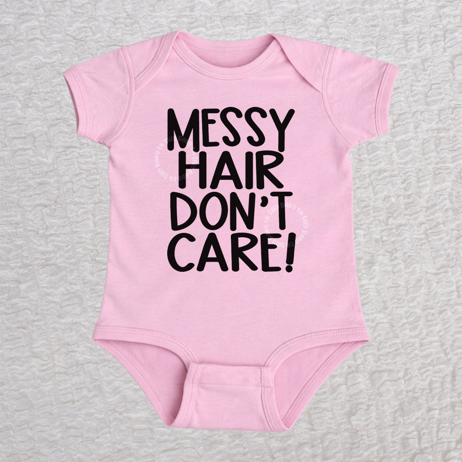 Messy Hair Don't Care short sleeve baby bodysuit in pink with playful typography design