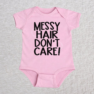 Messy Hair Don't Care short sleeve baby bodysuit in pink with playful typography design
