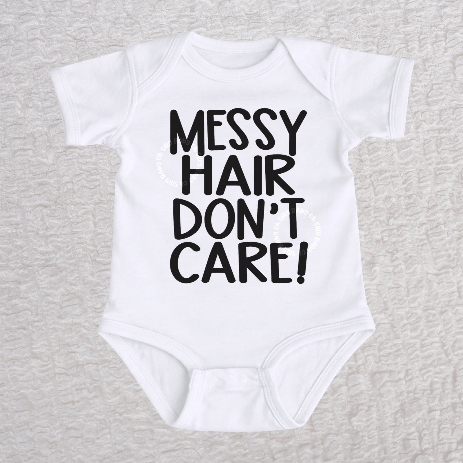 Messy Hair Don't Care short sleeve baby bodysuit in white with playful typography design