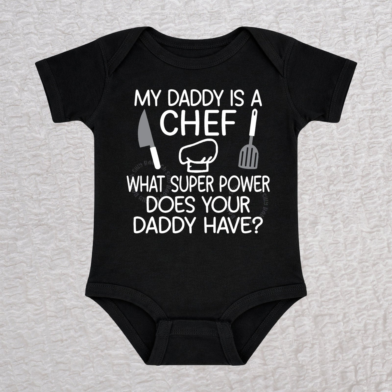 My Daddy Is a Chef short sleeve baby bodysuit in black with chef hat, knife and spatula design