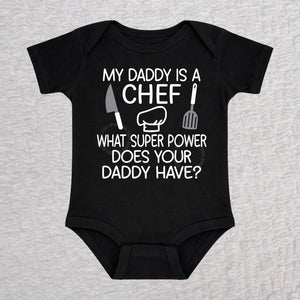 My Daddy Is a Chef short sleeve baby bodysuit in black with chef hat, knife and spatula design