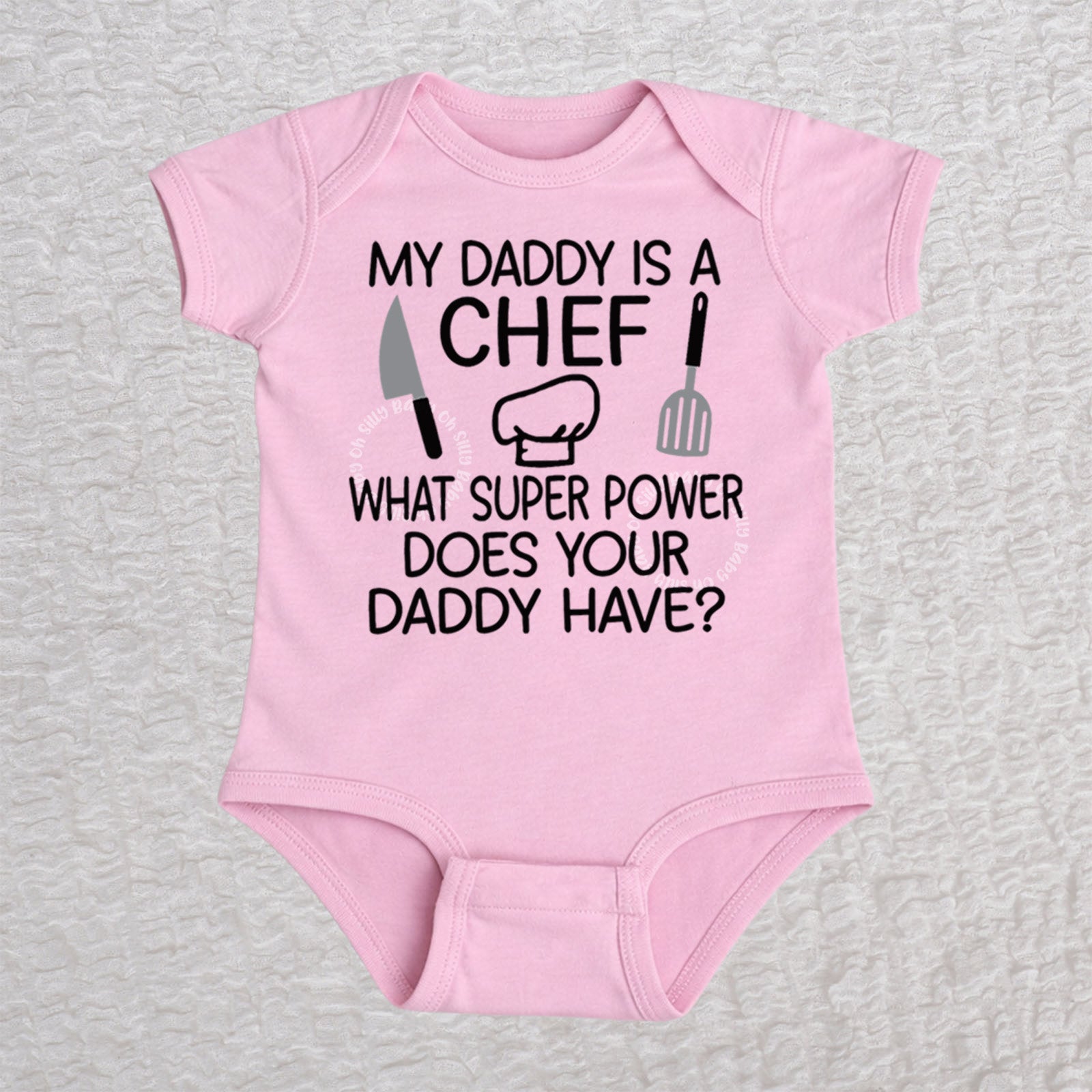 My Daddy Is a Chef short sleeve baby bodysuit in pink with chef hat, knife and spatula design