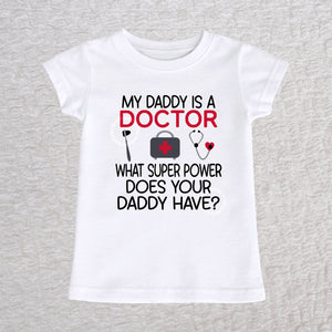 My Daddy Is a Doctor girls fit baby and toddler t-shirt in white featuring a reflex hammer, doctor's bag, and stethoscope design
