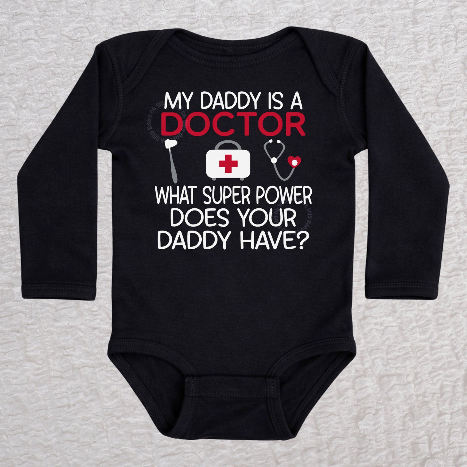 My Daddy Is a Doctor long sleeve baby bodysuit in black featuring a reflex hammer, doctor's bag, and stethoscope design