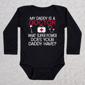 My Daddy Is a Doctor long sleeve baby bodysuit in black featuring a reflex hammer, doctor's bag, and stethoscope design