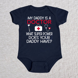 My Daddy Is a Doctor short sleeve baby bodysuit in navy featuring a reflex hammer, doctor's bag, and stethoscope design