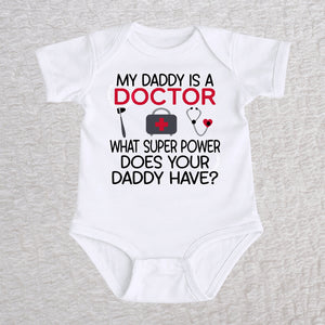 My Daddy Is a Doctor short sleeve baby bodysuit in white featuring a reflex hammer, doctor's bag, and stethoscope design