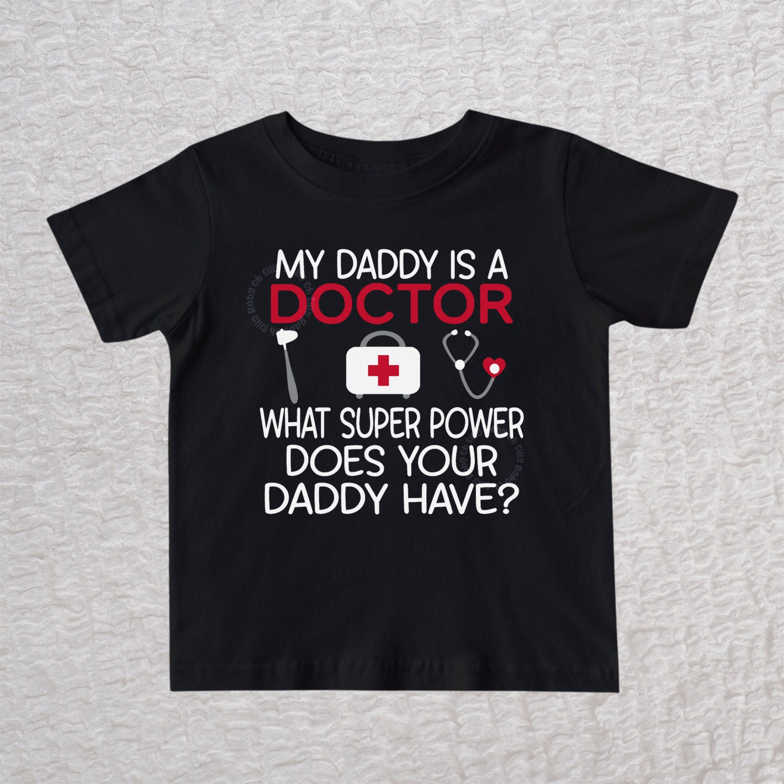 My Daddy Is a Doctor unisex baby and toddler t-shirt in black featuring a reflex hammer, doctor's bag, and stethoscope design