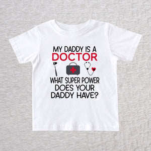 My Daddy Is a Doctor unisex baby and toddler t-shirt in white featuring a reflex hammer, doctor's bag, and stethoscope design