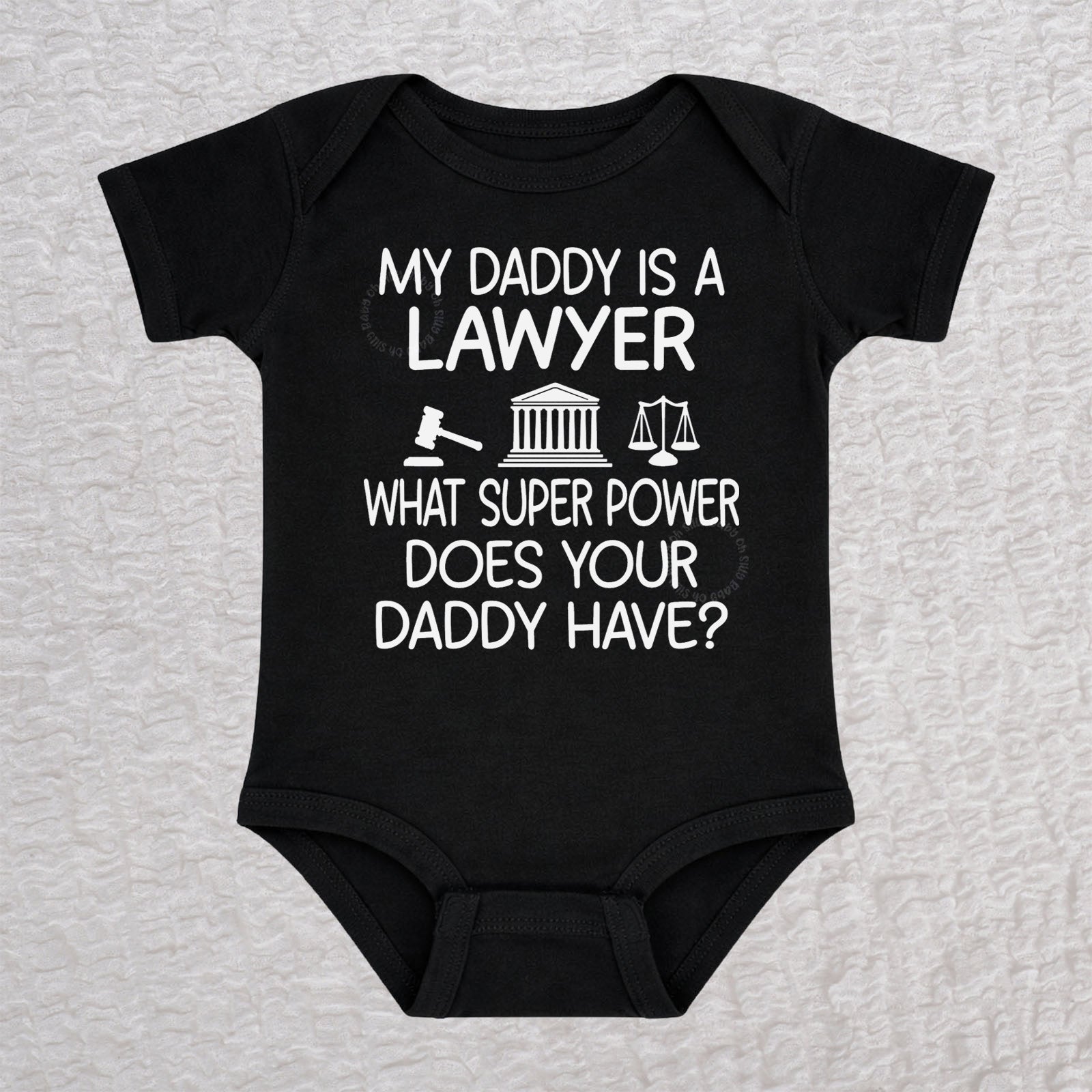 My Daddy Is a Lawyer short sleeve baby bodysuit in black featuring a gavel, courthouse, and scales of justice design