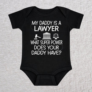 My Daddy Is a Lawyer short sleeve baby bodysuit in black featuring a gavel, courthouse, and scales of justice design