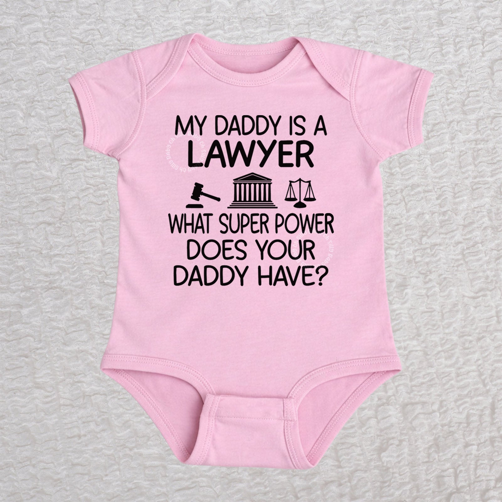 My Daddy Is a Lawyer short sleeve baby bodysuit in pink featuring a gavel, courthouse, and scales of justice design