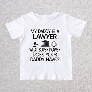 My Daddy Is a Lawyer unisex baby and toddler t-shirt in white featuring a gavel, courthouse, and scales of justice design