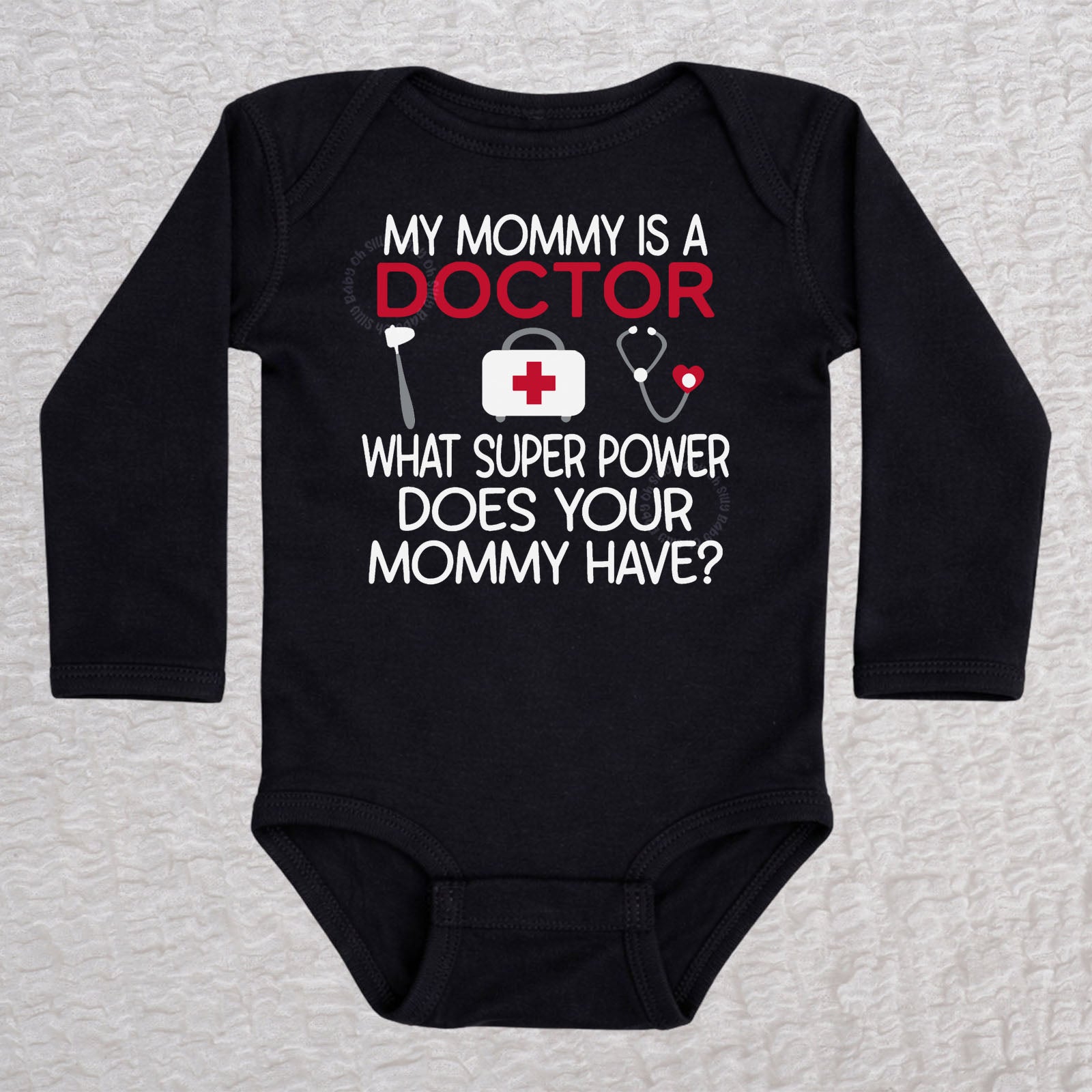My Mommy Is a Doctor long sleeve baby bodysuit in black featuring a reflex hammer, doctor's bag, and stethoscope design