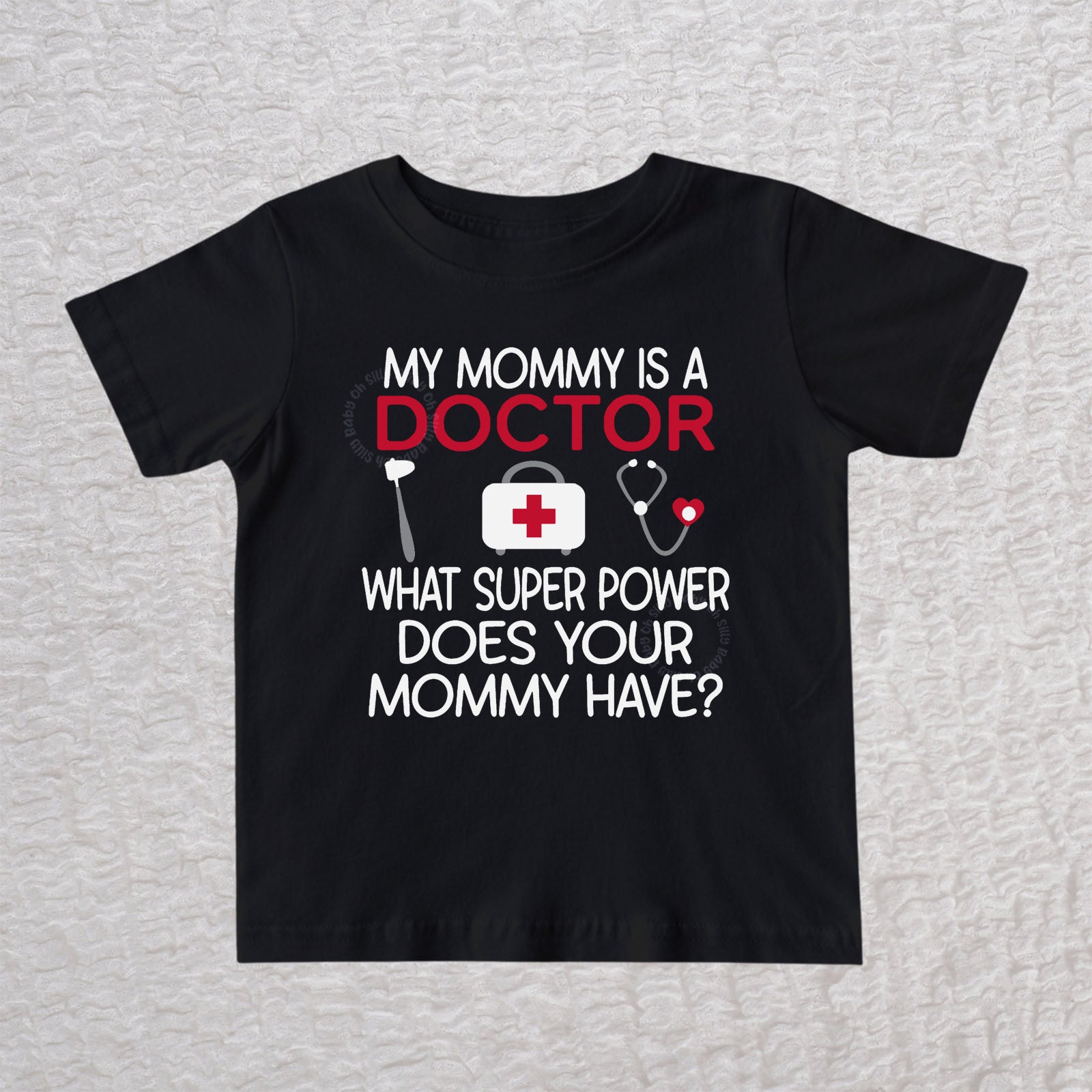 My Mommy Is a Doctor unisex baby and toddler t-shirt in black featuring a reflex hammer, doctor's bag, and stethoscope design