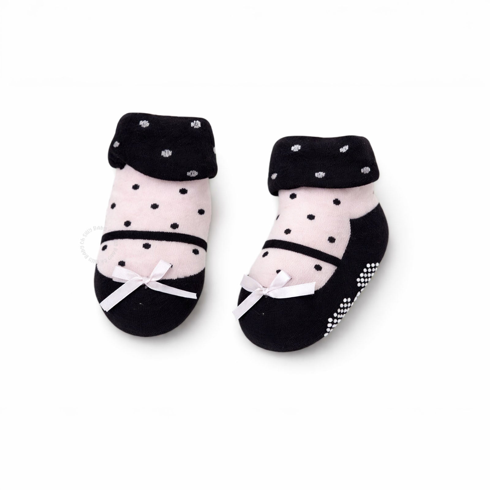 Pair of black and pink baby socks with polka dots 