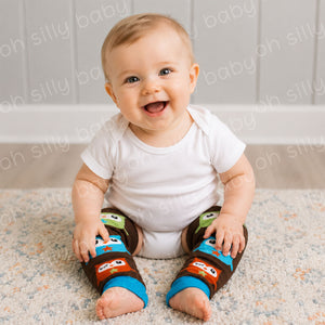 Baby wearing a white short sleeve bodysuit with Owl baby leg warmers