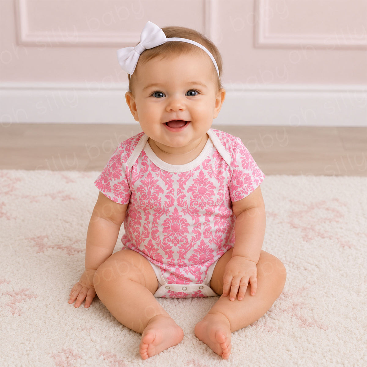 Baby girl wearing a Pink Damask Print baby bodysuit made from 100% cotton interlock knit fabric
