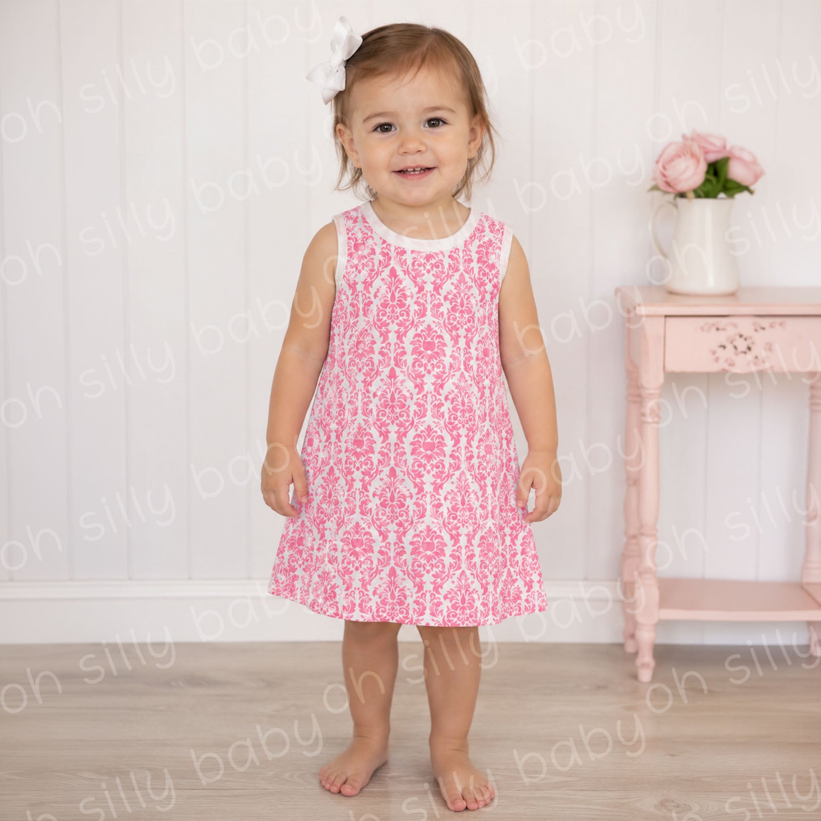 Toddler girl wearing a pink damask print girls dress in size 2/3T