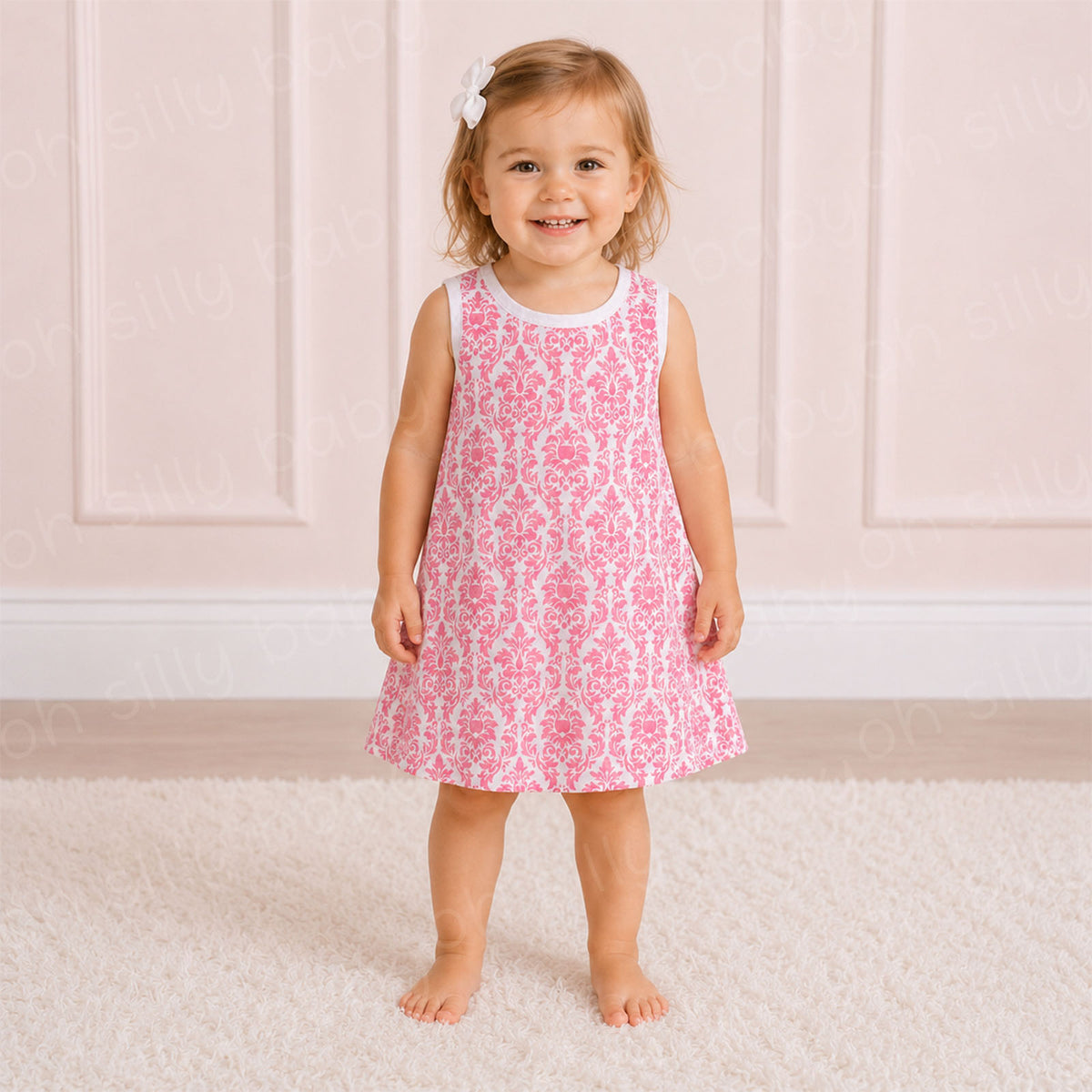 Toddler girl wearing a pink damask print girls dress in size 2/3T