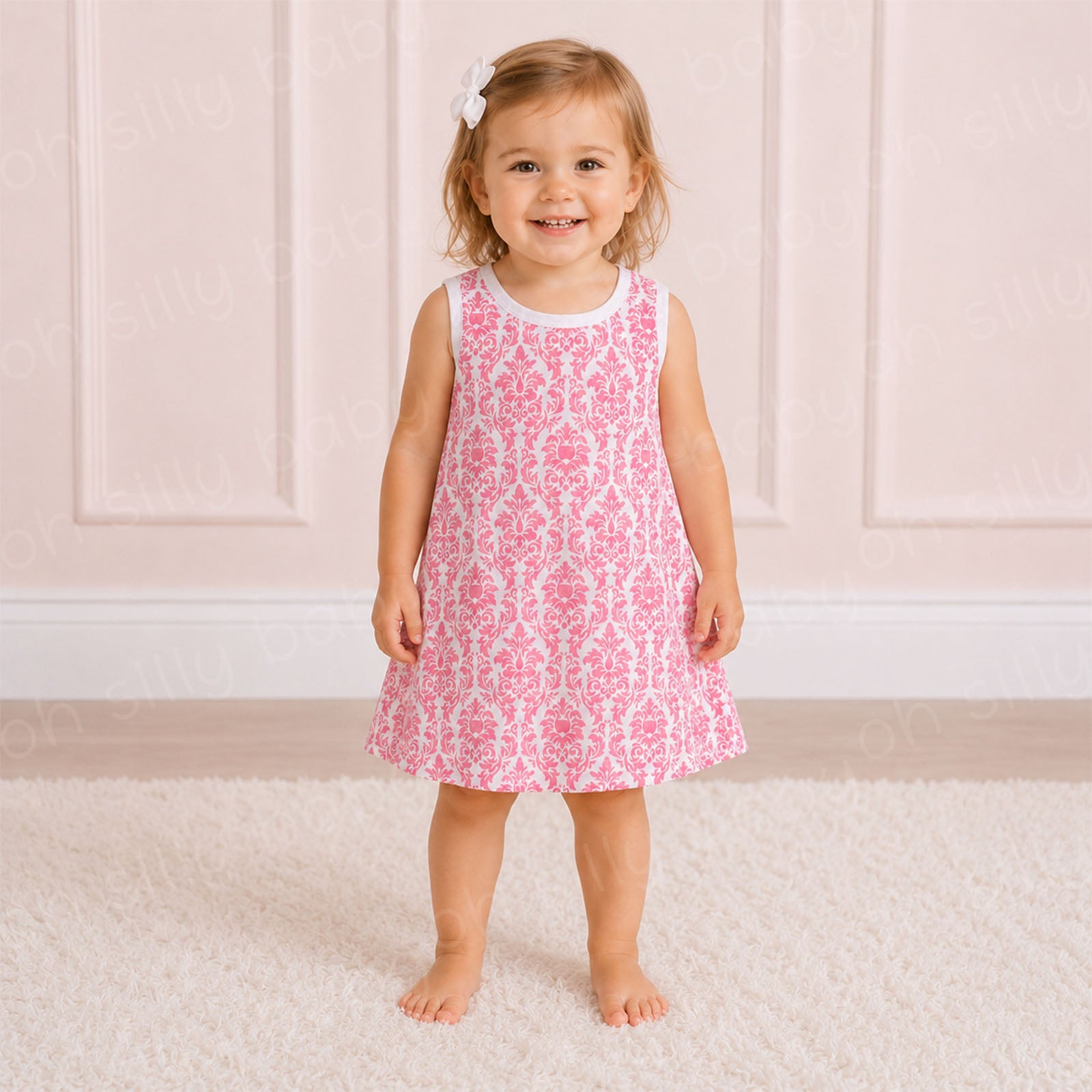 Toddler girl wearing a pink damask print girls dress in size 2/3T