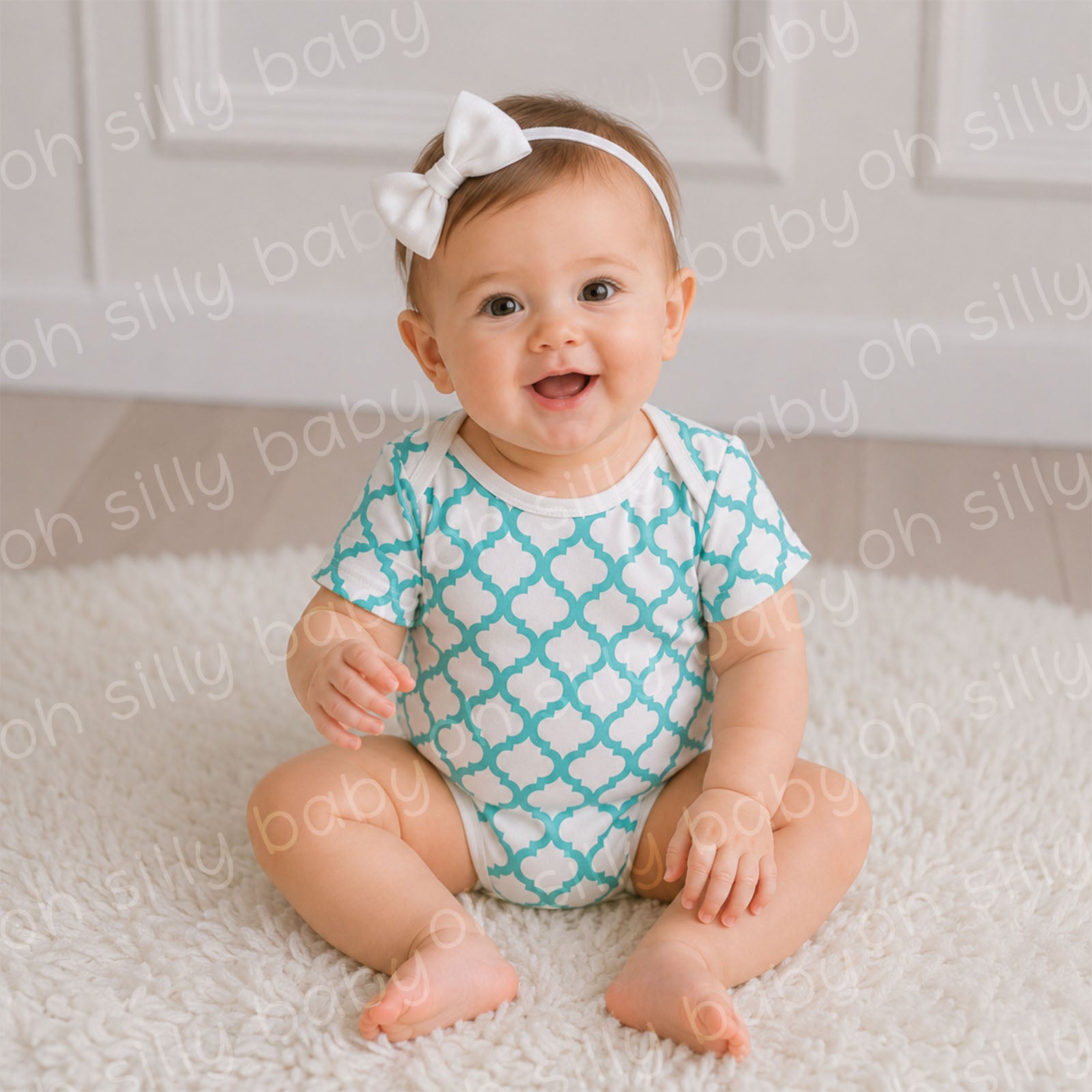 Baby wearing a turquoise and white Quatrefoil Print baby bodysuit