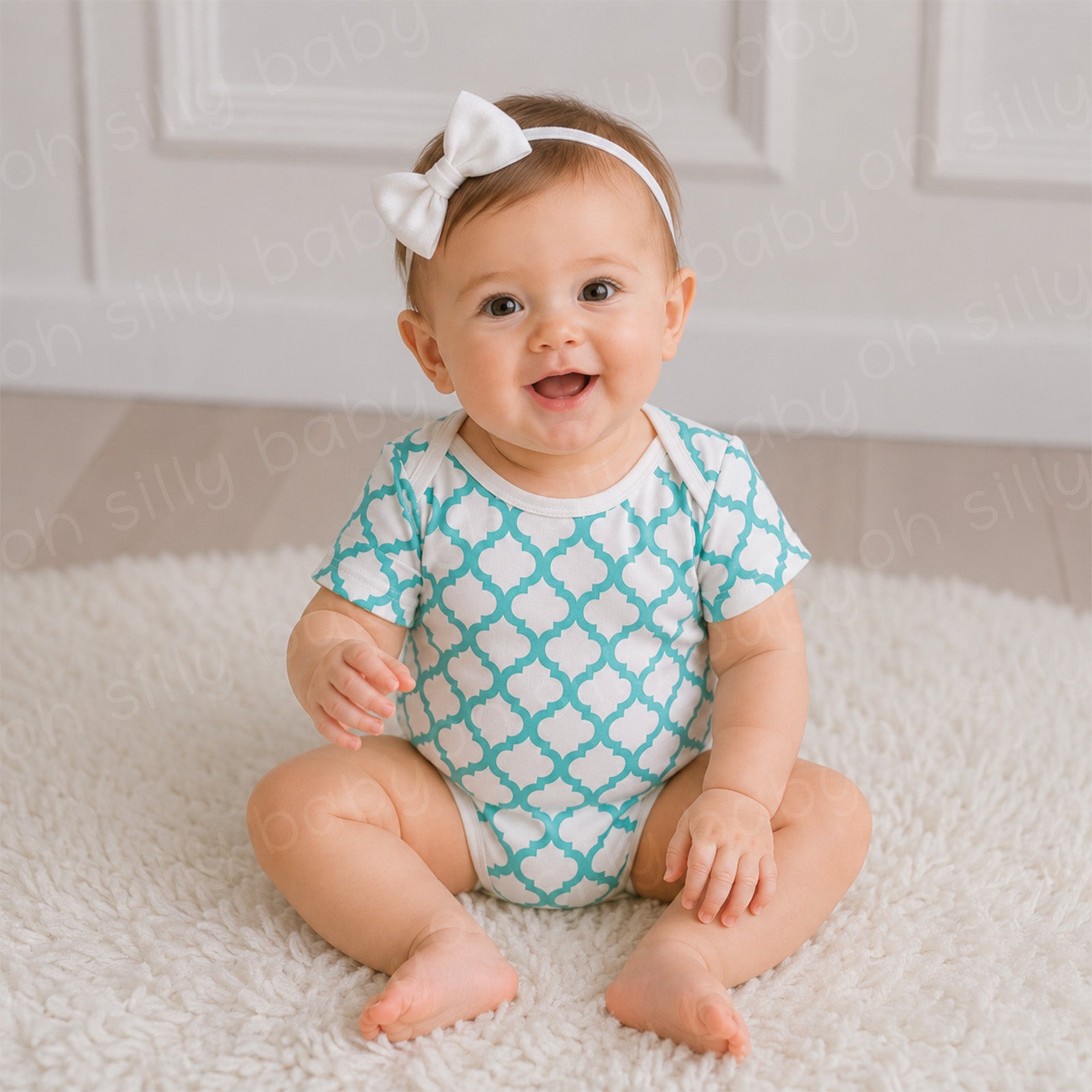 Baby wearing a turquoise and white Quatrefoil Print baby bodysuit