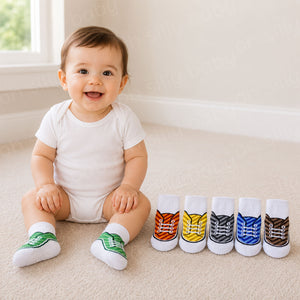 Baby wearing green Stetson Non-Skid Baby Socks with the remaining five sock color options displayed beside them