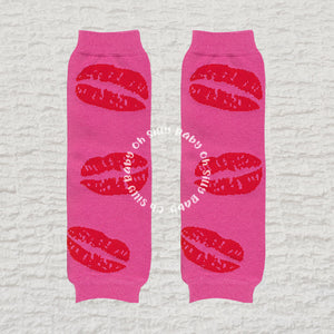 Kisses baby leg warmers with a pink kiss pattern on a hot pink background